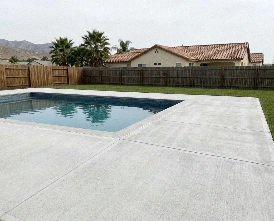 Broom finished concrete pool deck around an inground pool in Pomona